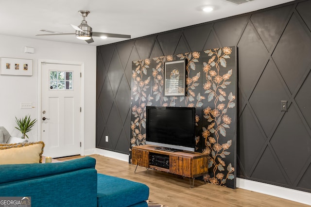 living room with ceiling fan and light hardwood / wood-style flooring