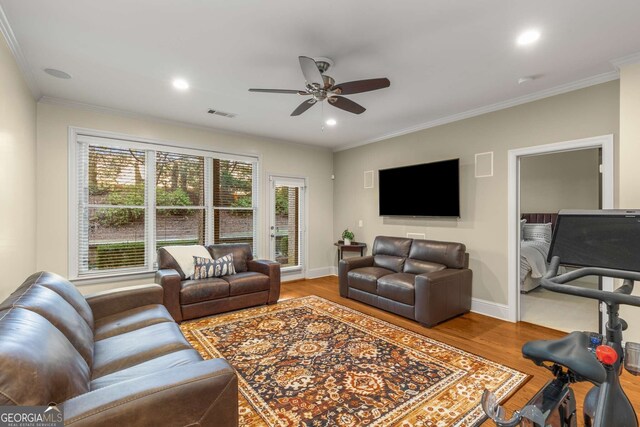 living room with ceiling fan, crown molding, and hardwood / wood-style flooring