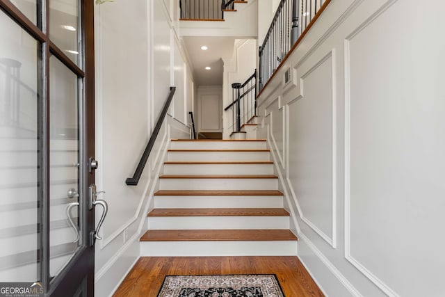 dining space featuring beam ceiling, a chandelier, wood-type flooring, and ornamental molding