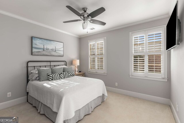 carpeted bedroom with ceiling fan, a closet, and ornamental molding