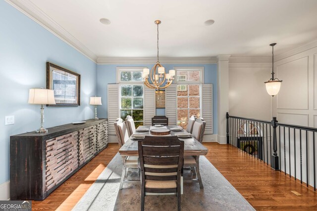 kitchen with appliances with stainless steel finishes, light hardwood / wood-style floors, backsplash, a breakfast bar, and a center island with sink