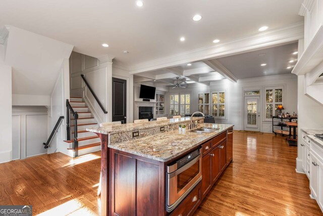 kitchen with stainless steel appliances, white cabinets, tasteful backsplash, and custom range hood