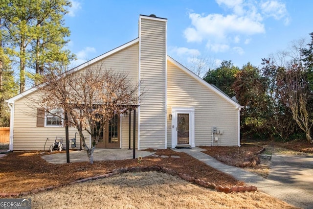 rear view of property with french doors and a patio