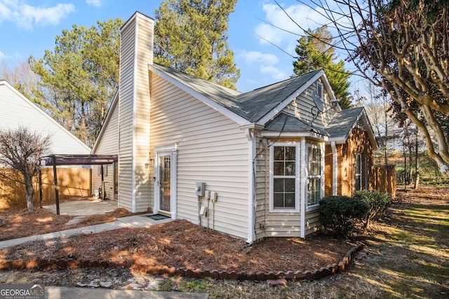 view of home's exterior featuring a carport