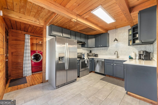 kitchen featuring appliances with stainless steel finishes, washer / clothes dryer, decorative light fixtures, beamed ceiling, and backsplash