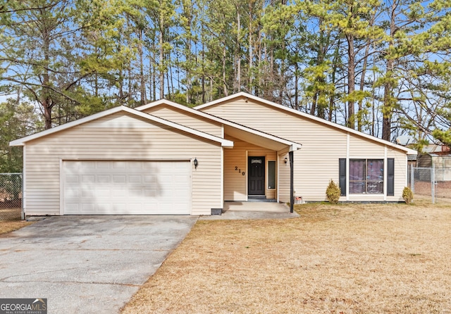 ranch-style house featuring a garage and a front yard