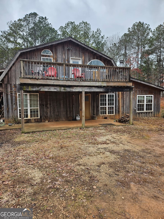 back of property with a wooden deck