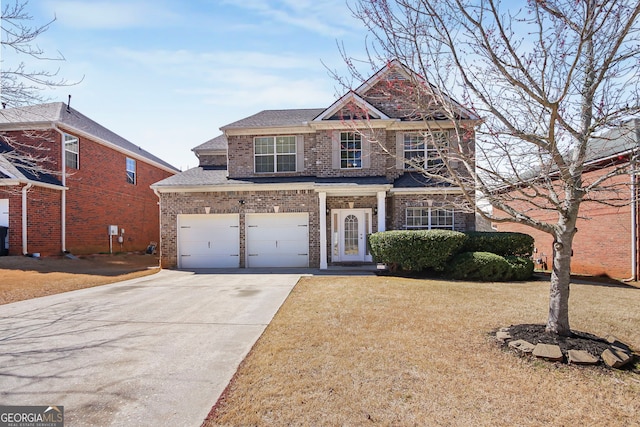 view of front of home with concrete driveway, brick siding, a front lawn, and an attached garage