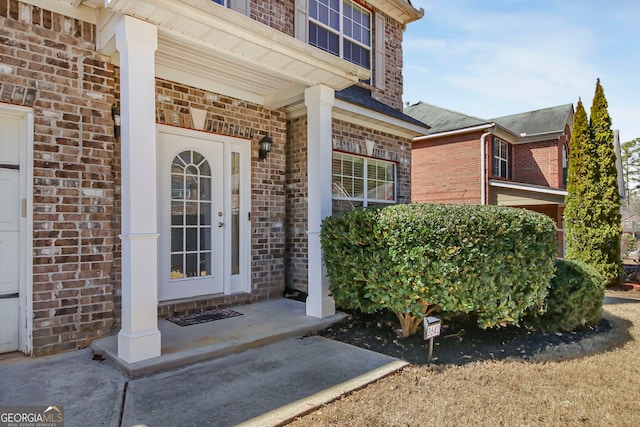 doorway to property with brick siding