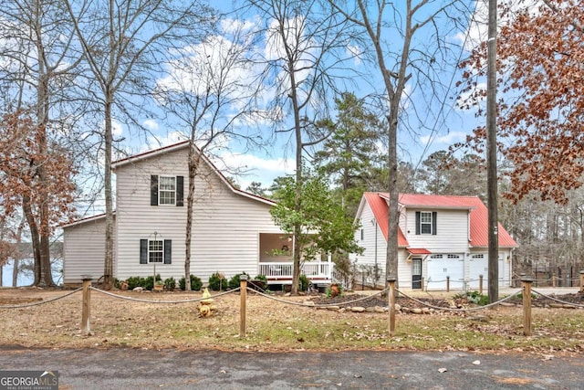 view of front facade with covered porch and a garage