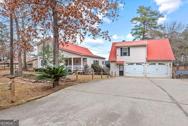 view of front of property featuring covered porch and a garage