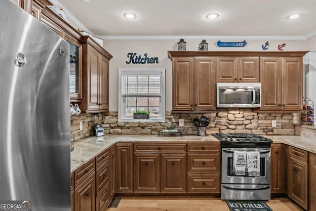 kitchen with light stone counters, stainless steel appliances, and tasteful backsplash