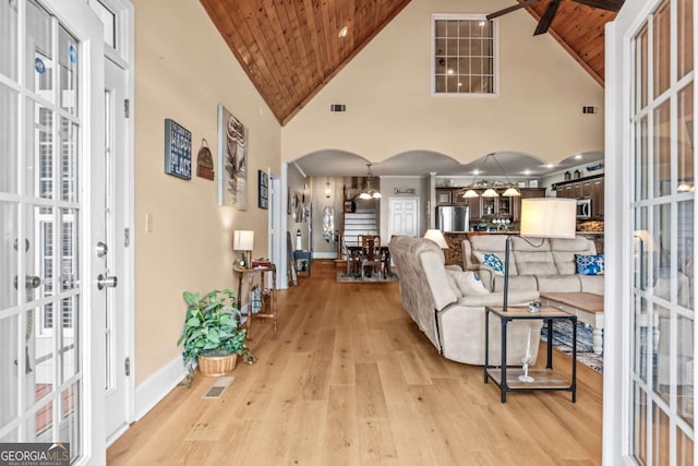 living room featuring high vaulted ceiling, wooden ceiling, and light hardwood / wood-style flooring