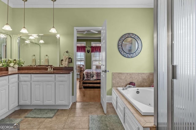 bathroom with a tub, vanity, tile patterned flooring, and ornamental molding