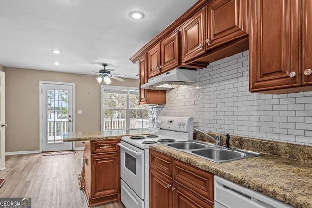 kitchen featuring ceiling fan, decorative backsplash, sink, white appliances, and light wood-type flooring