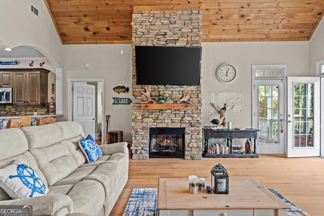 163 NE Knight Dr, Milledgeville, GA 31061 - living area with wood ceiling, wood finished floors, high vaulted ceiling, and a stone fireplace
