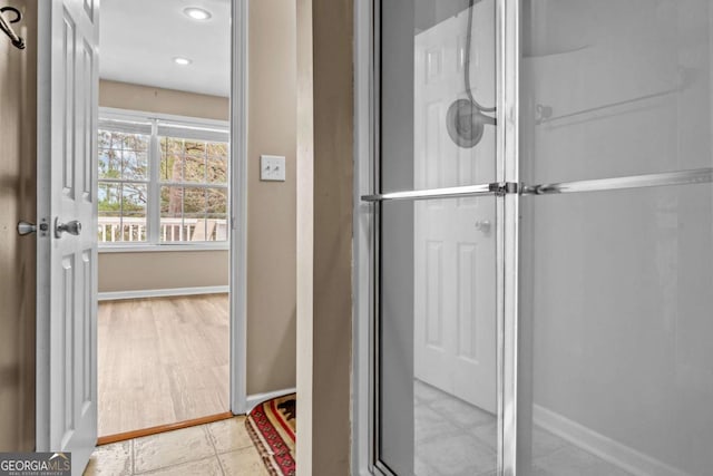 bathroom featuring a shower with door and tile patterned floors