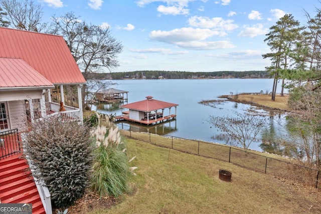 dock area featuring a yard and a water view