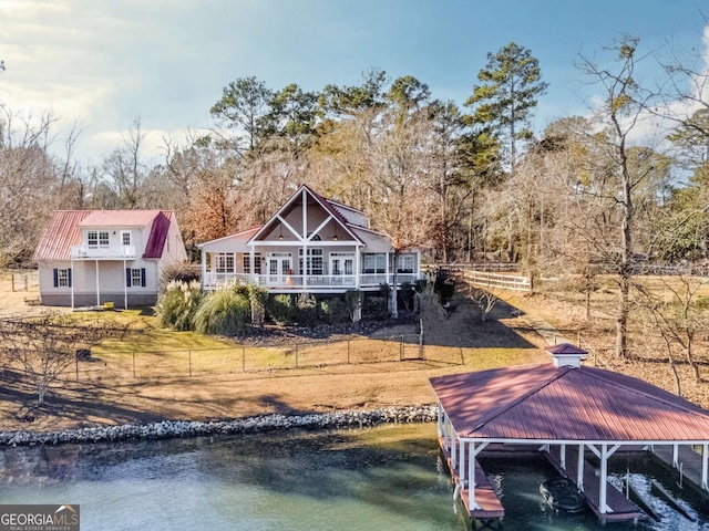 rear view of property with a water view