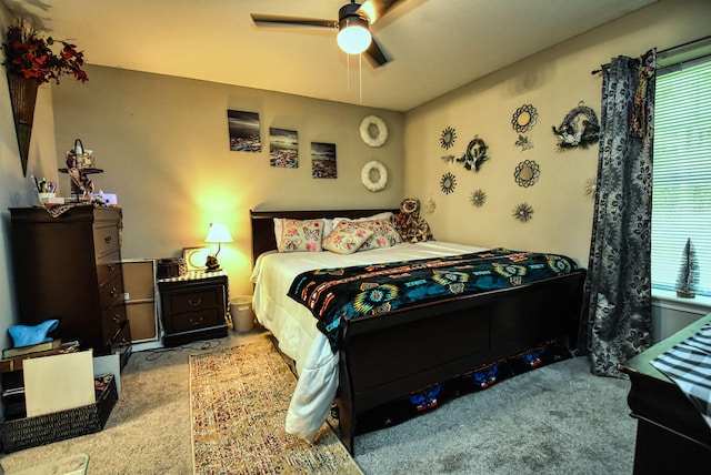 carpeted bedroom featuring ceiling fan and multiple windows