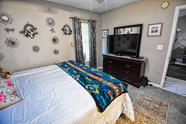 bedroom featuring a textured ceiling and carpet flooring