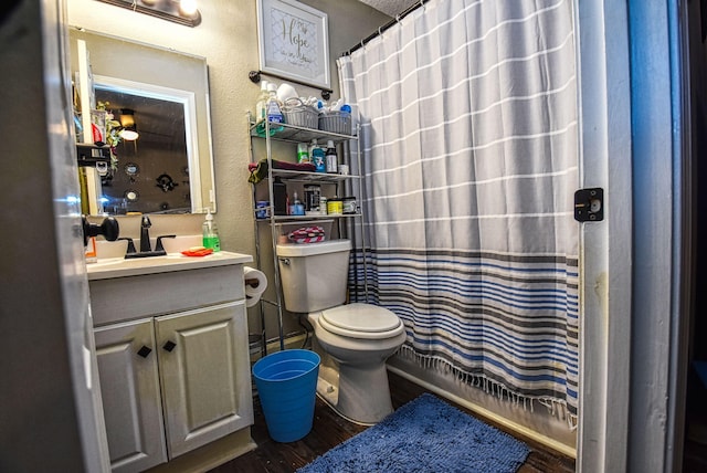 bathroom featuring a textured ceiling, toilet, vanity, and a shower with shower curtain