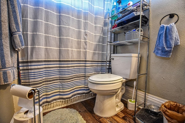 bathroom with toilet and wood-type flooring