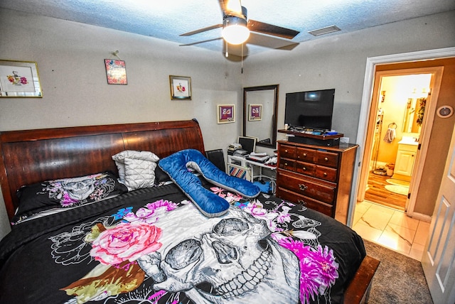 tiled bedroom featuring ceiling fan and connected bathroom