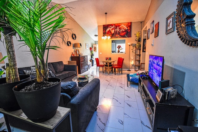 living room with vaulted ceiling and a notable chandelier