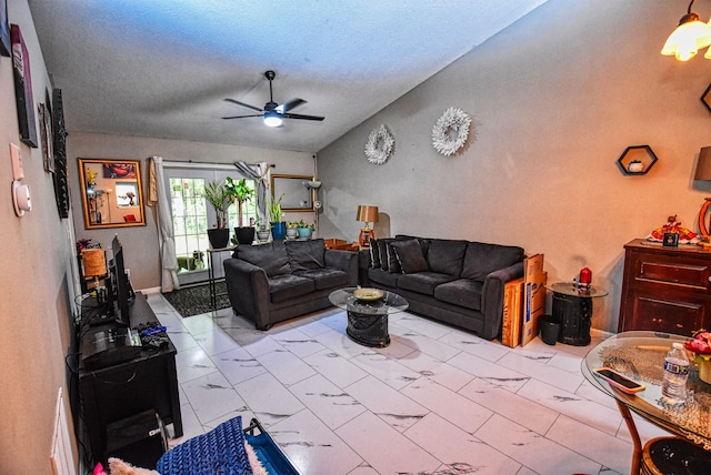 living room with ceiling fan and a textured ceiling