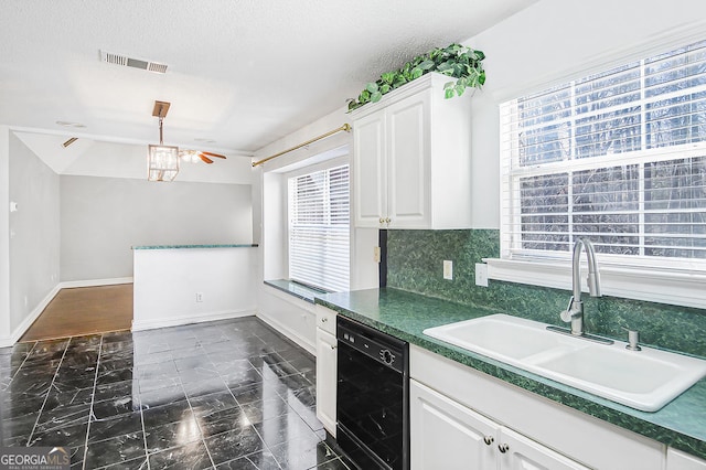 kitchen featuring black dishwasher, sink, decorative backsplash, and white cabinets