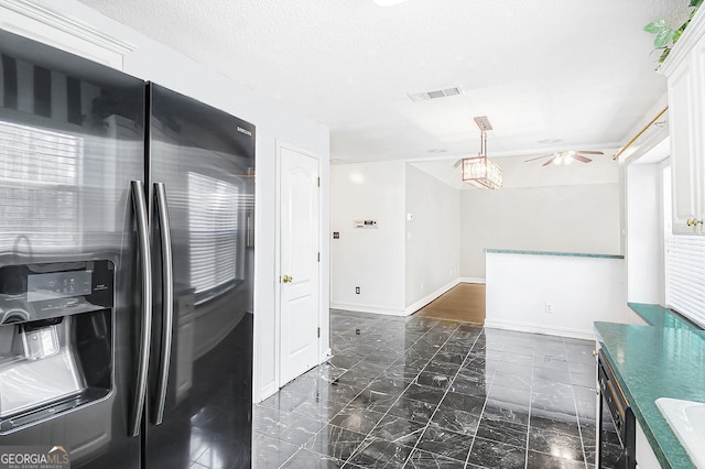 kitchen featuring sink, ceiling fan, white cabinetry, black dishwasher, and stainless steel refrigerator with ice dispenser