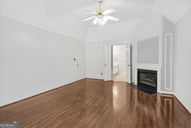 unfurnished living room featuring dark wood-type flooring, vaulted ceiling, and ceiling fan