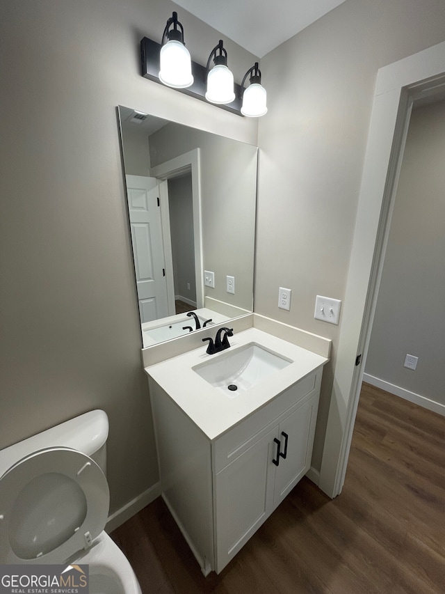 410 Hardy Ave SW, Rome, GA 30161 - half bath with vanity, baseboards, toilet, and wood finished floors