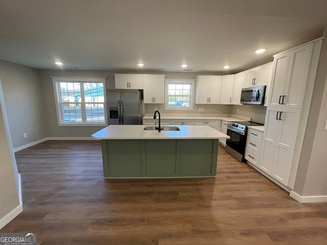410 Hardy Ave SW, Rome, GA 30161 - kitchen with stainless steel appliances, an island with sink, baseboards, and a sink