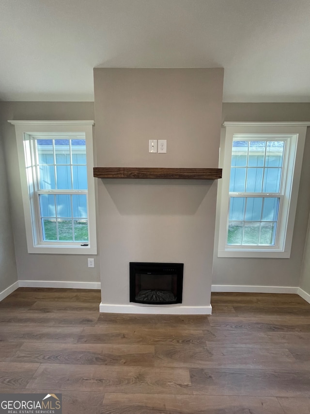 410 Hardy Ave SW, Rome, GA 30161 - unfurnished living room with baseboards, a wealth of natural light, and wood finished floors