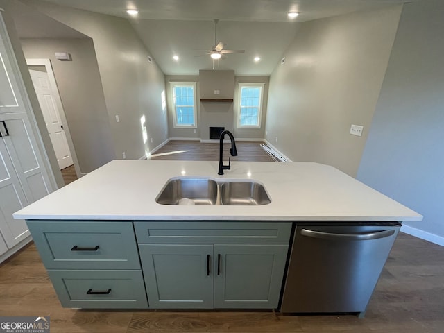 410 Hardy Ave SW, Rome, GA 30161 - kitchen featuring baseboards, an island with sink, light countertops, stainless steel dishwasher, and a sink