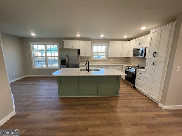 410 Hardy Ave SW, Rome, GA 30161 - kitchen featuring an island with sink, white cabinetry, appliances with stainless steel finishes, a sink, and baseboards