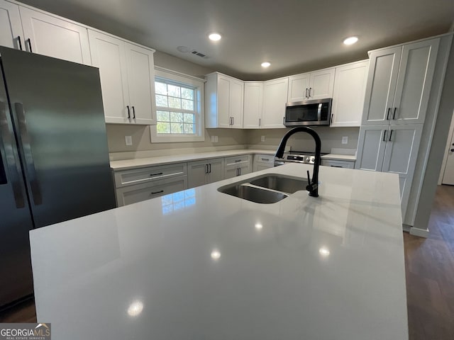 410 Hardy Ave SW, Rome, GA 30161 - kitchen featuring dark wood-style flooring, light countertops, white cabinets, stainless steel appliances, and a sink