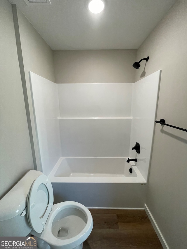 410 Hardy Ave SW, Rome, GA 30161 - bathroom with toilet, baseboards, wood finished floors, and shower / bathtub combination