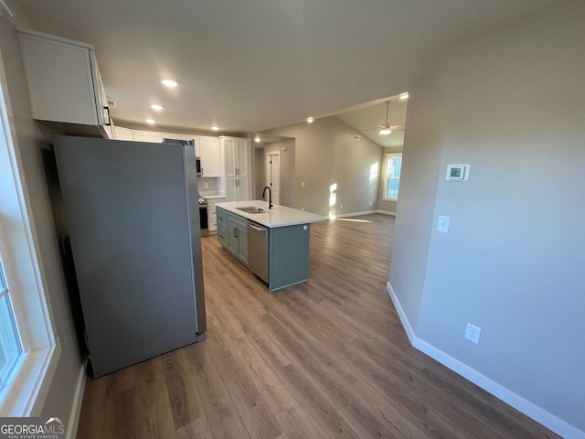 410 Hardy Ave SW, Rome, GA 30161 - kitchen with white cabinets, wood finished floors, a sink, stainless steel appliances, and baseboards