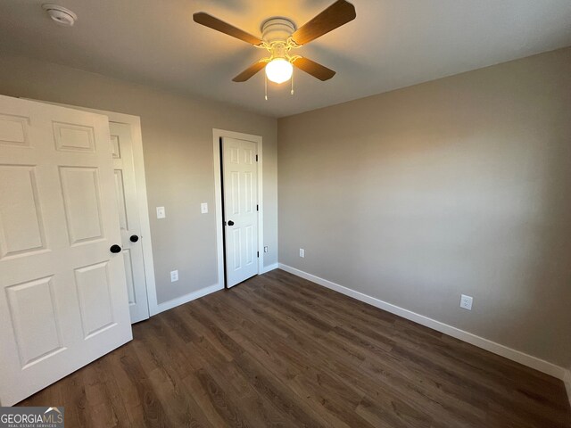 410 Hardy Ave SW, Rome, GA 30161 - unfurnished bedroom featuring a ceiling fan, baseboards, and dark wood finished floors