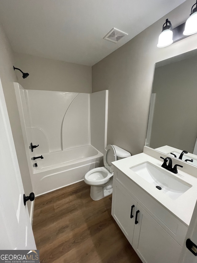 410 Hardy Ave SW, Rome, GA 30161 - bathroom with vanity, visible vents, toilet, wood finished floors, and washtub / shower combination