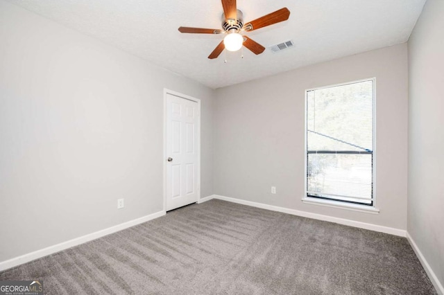 empty room featuring carpet and ceiling fan