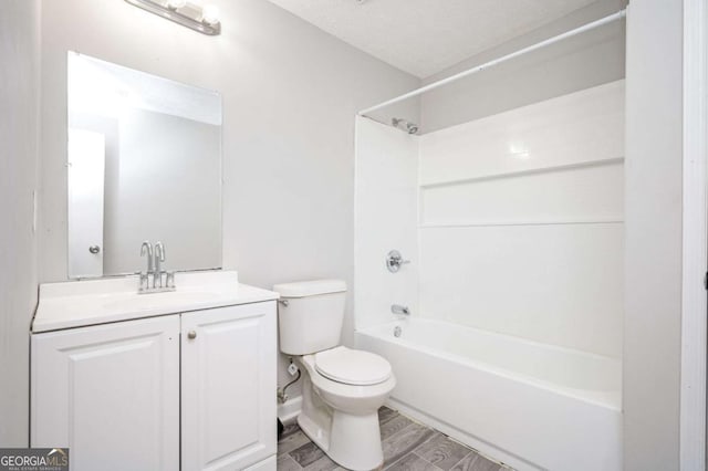 full bathroom featuring a textured ceiling, toilet, vanity, and  shower combination