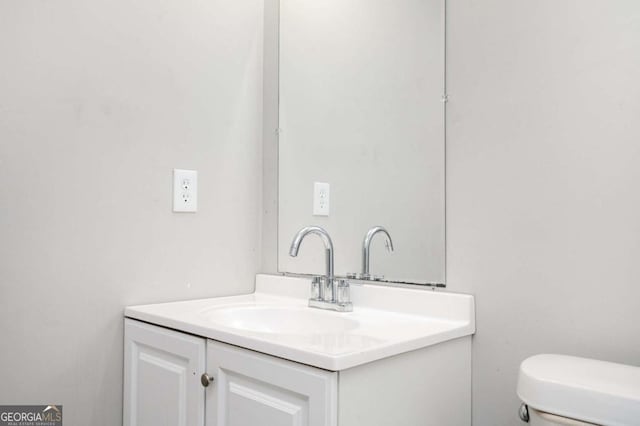 bathroom with toilet and vanity