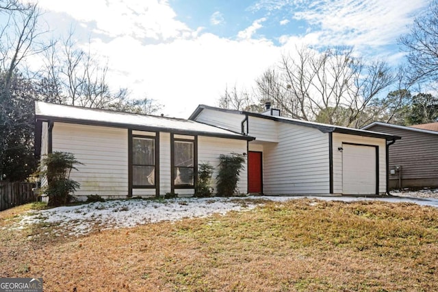 ranch-style house with a garage and a front yard