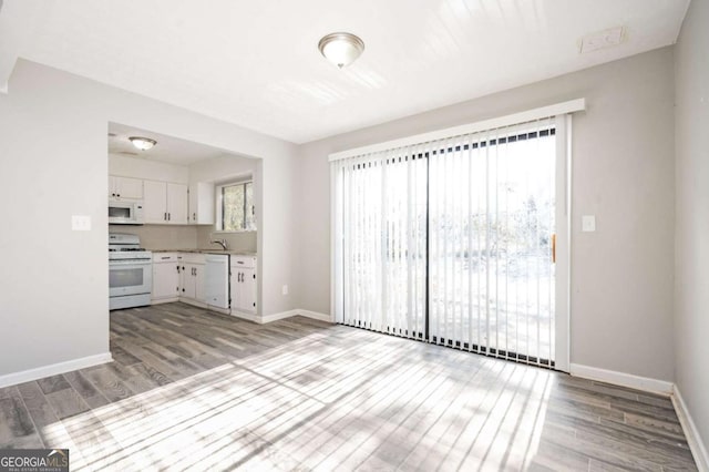 kitchen featuring light hardwood / wood-style floors, sink, white appliances, and white cabinets