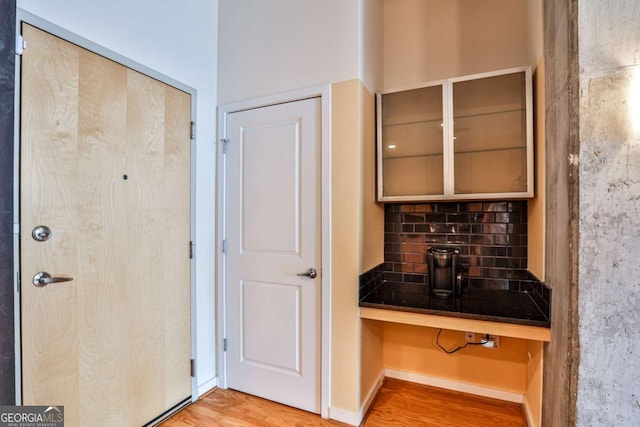 interior space featuring decorative backsplash and hardwood / wood-style floors