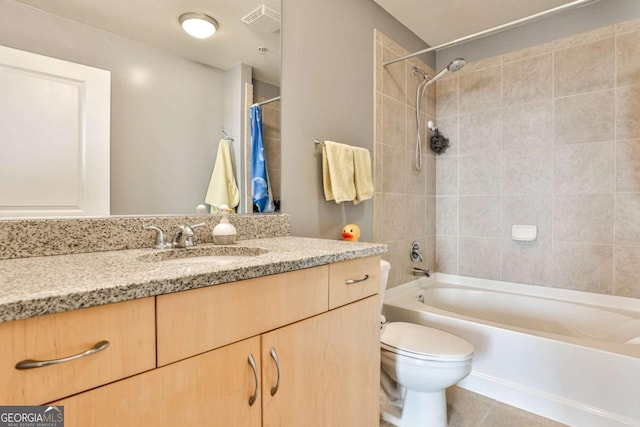 full bathroom featuring tile patterned flooring, toilet, vanity, and shower / bath combination with curtain